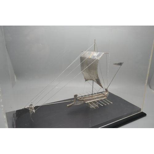 900 - A silver model of an ancient Greek warship, marked 925 and 999, in a Perspex case, height of case 19... 