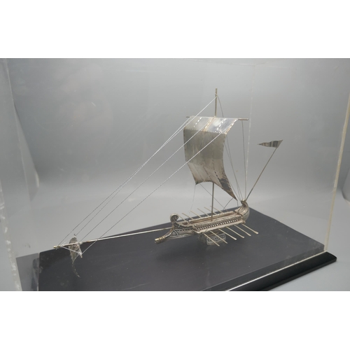 900 - A silver model of an ancient Greek warship, marked 925 and 999, in a Perspex case, height of case 19... 