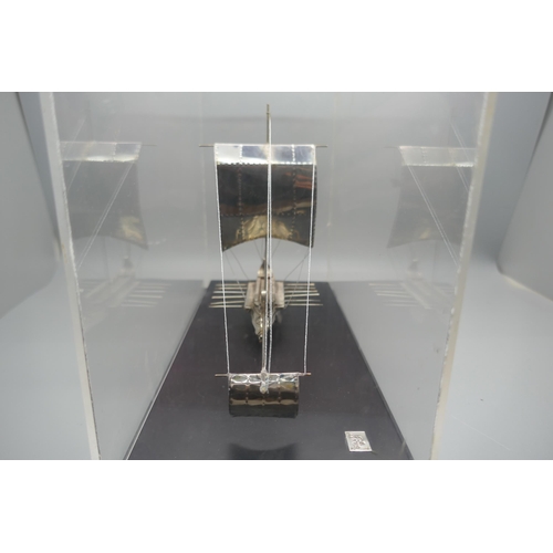 900 - A silver model of an ancient Greek warship, marked 925 and 999, in a Perspex case, height of case 19... 