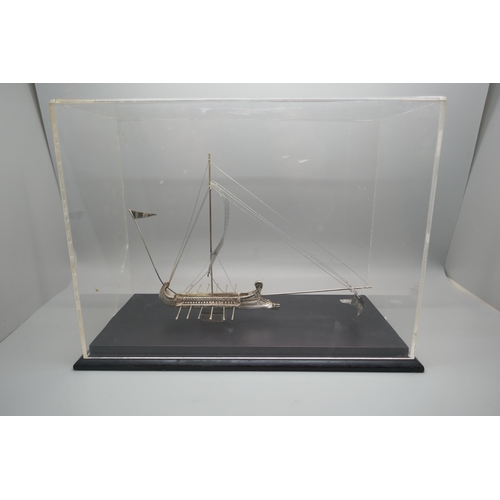 900 - A silver model of an ancient Greek warship, marked 925 and 999, in a Perspex case, height of case 19... 