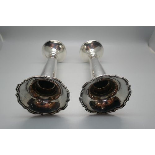 902 - A pair of Walker & Hall silver vases, weighted, 17.5cm