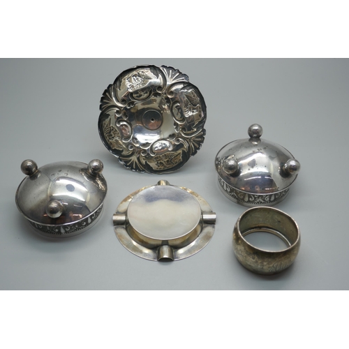 905 - A silver Reynolds Angels ring stand, Birmingham 1907, a silver ashtray, a silver napkin ring and a p... 