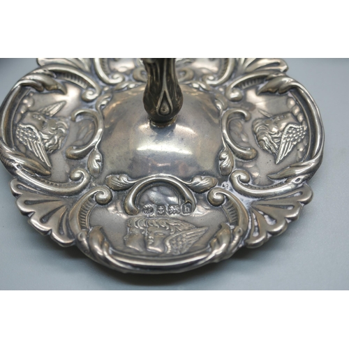 905 - A silver Reynolds Angels ring stand, Birmingham 1907, a silver ashtray, a silver napkin ring and a p... 