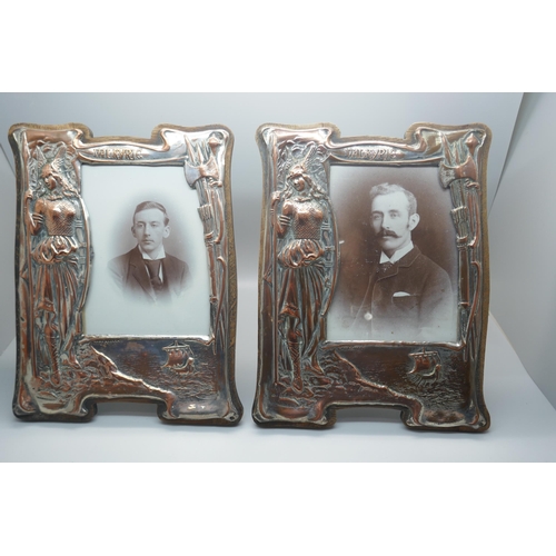 908 - A pair of Edwardian copper and brass frames with wooden panel backs, Viking scenes embossed, height ... 