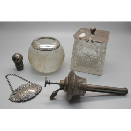 909 - A silver rimmed match striker, a silver topped cut crystal pot, a silver sherry label, a silver scen... 