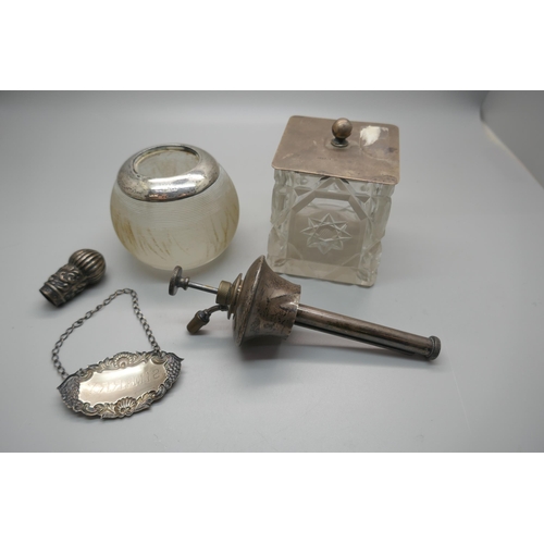 909 - A silver rimmed match striker, a silver topped cut crystal pot, a silver sherry label, a silver scen... 