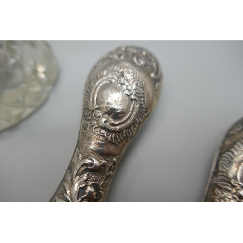 912 - A pair of silver handled glove stretchers, silver handled magnifying glass, a silver topped glass ha... 