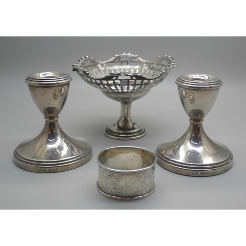 916 - A pair of silver dwarf candlesticks, a silver pedestal bon-bon dish and a silver napkin ring, (dish ... 