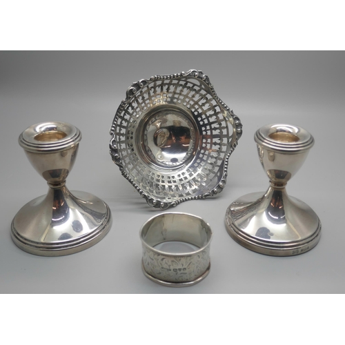 916 - A pair of silver dwarf candlesticks, a silver pedestal bon-bon dish and a silver napkin ring, (dish ... 