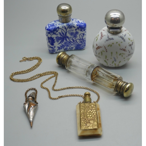 918 - Five scent bottles; a blue and white porcelain scent flask, a Victorian clear glass double ended, wh... 