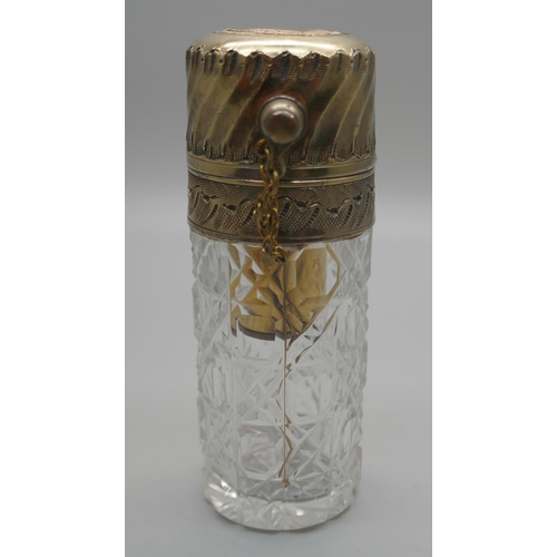 931 - A cut glass atomiser with gilt metal top, scratched initial 'M'