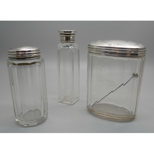 953 - Three silver topped jars, including London 1899, (oval), and Birmingham 1897, (medium)