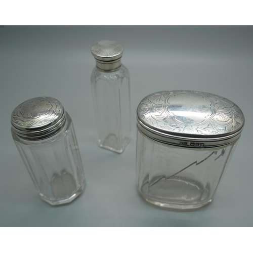 953 - Three silver topped jars, including London 1899, (oval), and Birmingham 1897, (medium)