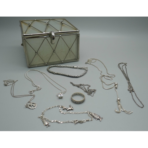 961 - Seven silver chains, three with pendants and a silver gilt stone set ring in a glass jewellery box