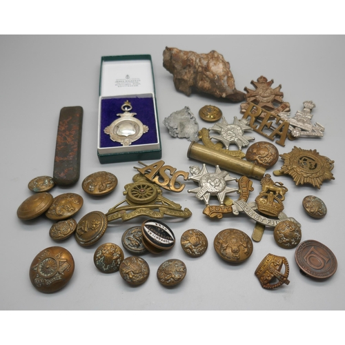 962 - Military cap badges, a piece of schrapnel and a silver fob medal