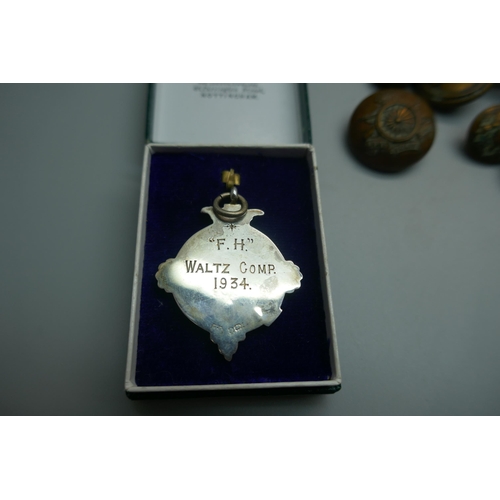 962 - Military cap badges, a piece of schrapnel and a silver fob medal