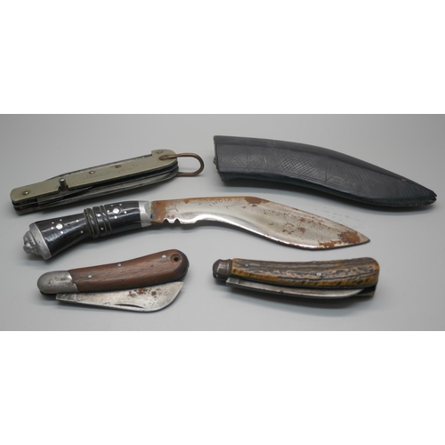 966 - A military issue knife, two other knives and a small kukri