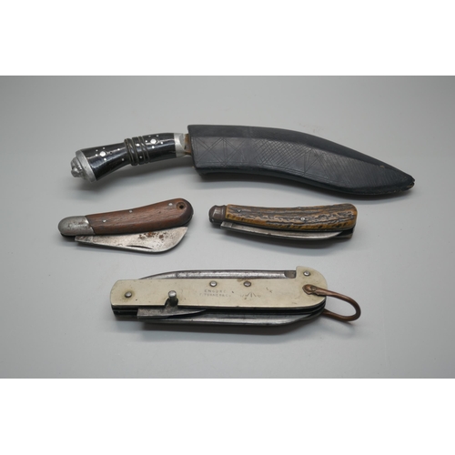 966 - A military issue knife, two other knives and a small kukri