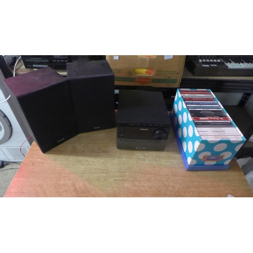 2128 - A Phillips CD player (BTM2310105) with matching speakers and a box of CDs