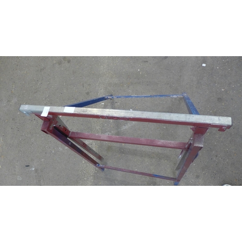 2238 - A metal folding trestle table and a plaster board support tool