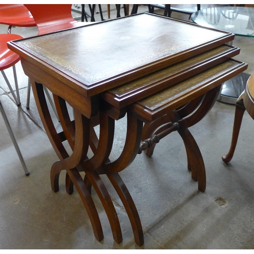 112 - A Regency style oak and green leather topped nest of tables and a walnut occasional table