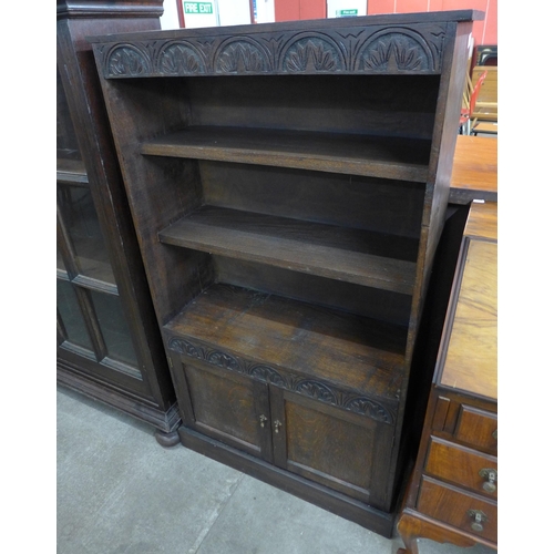 129 - An early 20th Century Jacobean Revival carved oak open bookcase