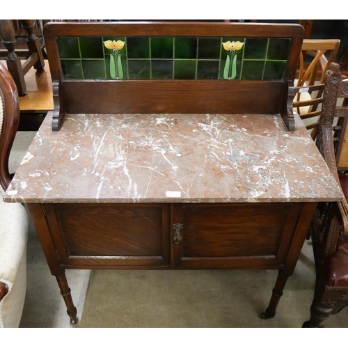 191 - An Edward VII oak and marble topped washstand with Art Nouveau green tiled splash back