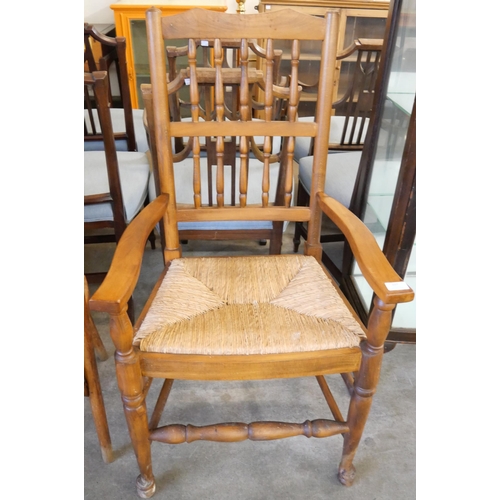 207 - A George III provincial fruitwood and rush seated elbow chair