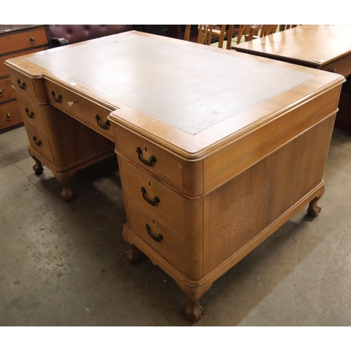 227 - A George III style walnut and leather topped library desk