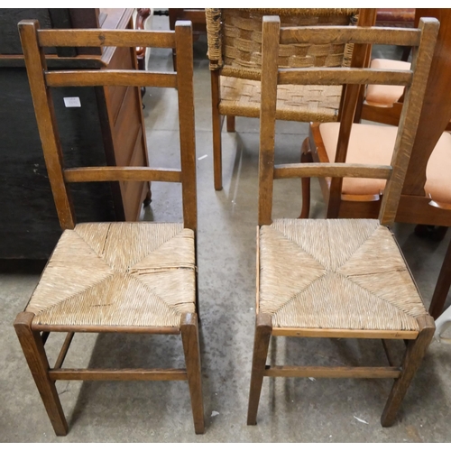 231 - A pair of Edward VII beech rush seated bedroom chairs and an ottoman