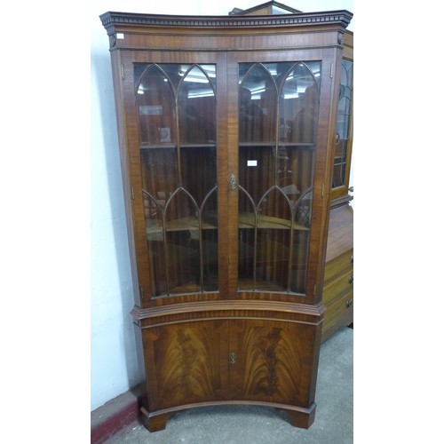 252 - A Regency style mahogany freestanding concave corner cabinet