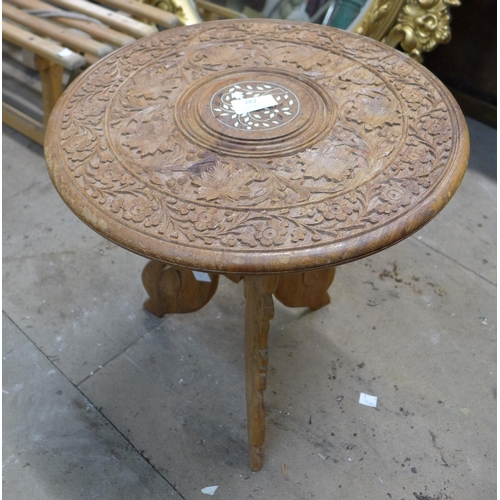 282 - An Eastern carved wood and faux ivory inlaid occasional table