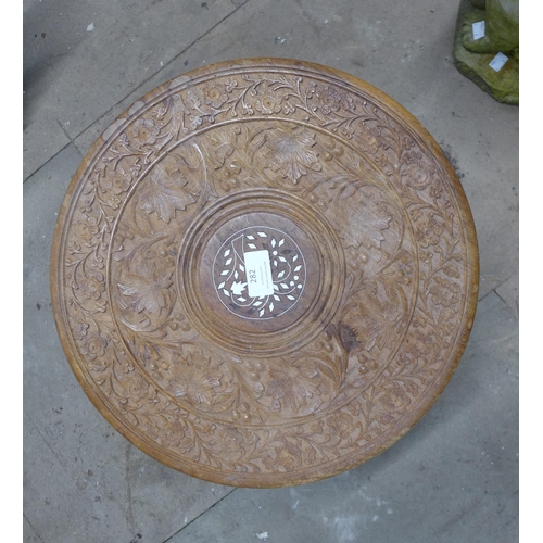 282 - An Eastern carved wood and faux ivory inlaid occasional table