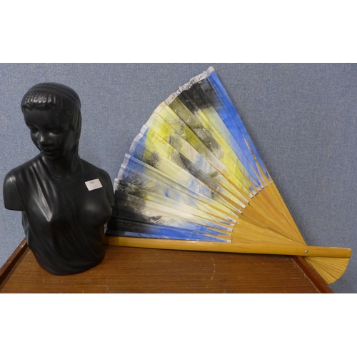 343 - A black porcelain bust of a lady and a large oriental fan