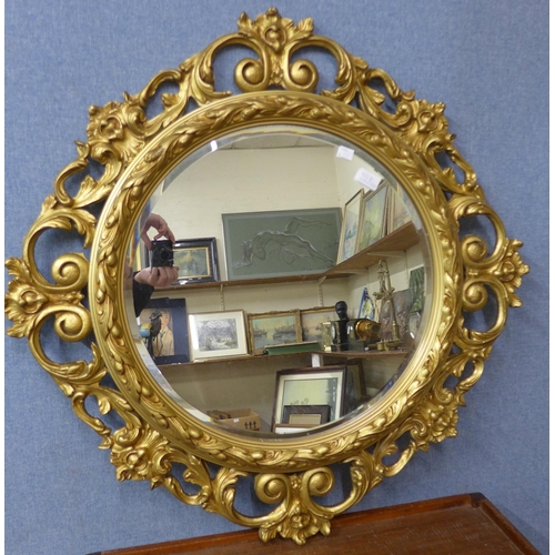 355B - A French style circular gilt framed mirror