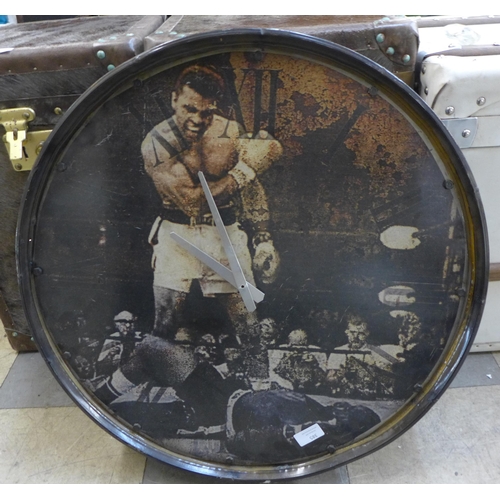 385 - A Muhammed Ali metal wall clock