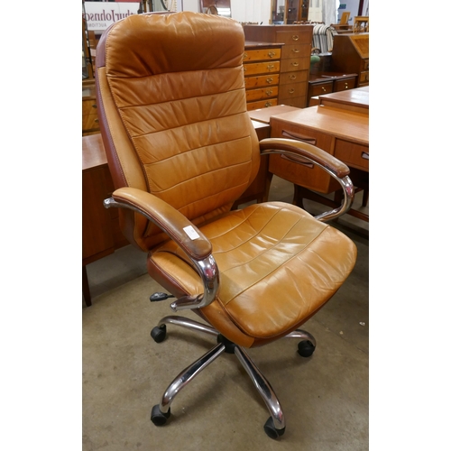 39 - A tan leather and chrome revolving desk chair