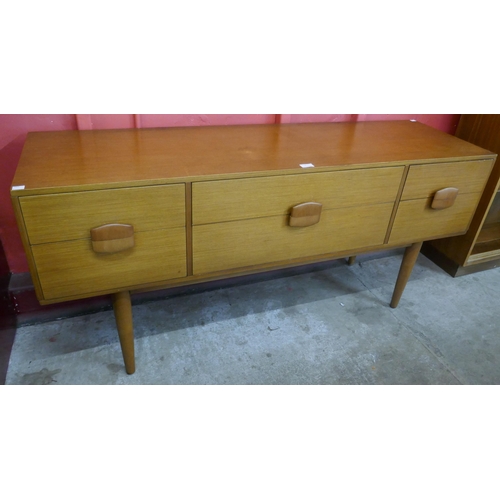 4 - A teak six drawer sideboard