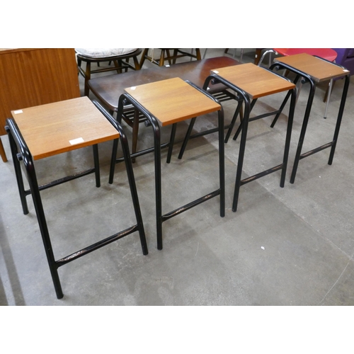 66 - A set of four teak and black tubular metal stools