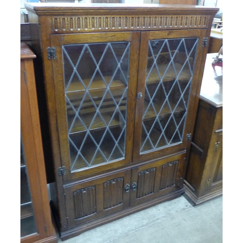 95 - An oak four door bookcase