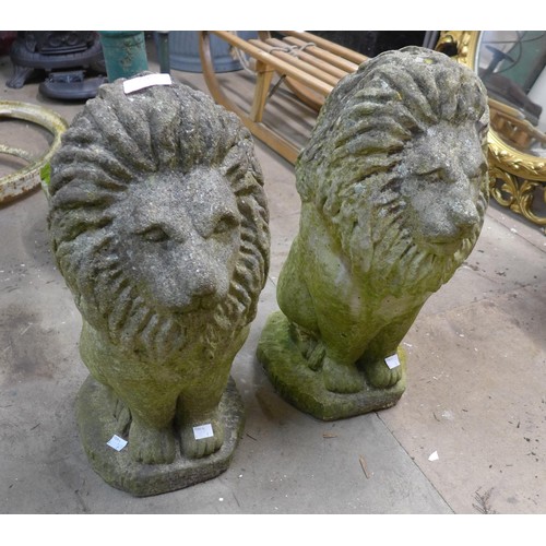 276 - A pair of concrete garden figures of seated lions