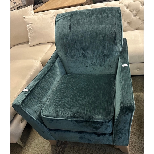 1310 - A turquoise velvet upholstered armchair