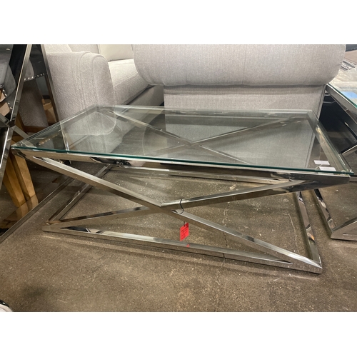 1389 - A glass and chrome 'X' base coffee table * this lot is subject to VAT