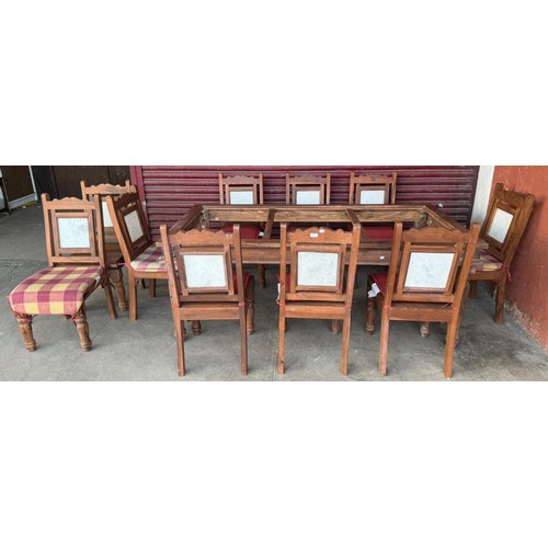 197 - An eastern hardwood and marble topped dining table and chairs