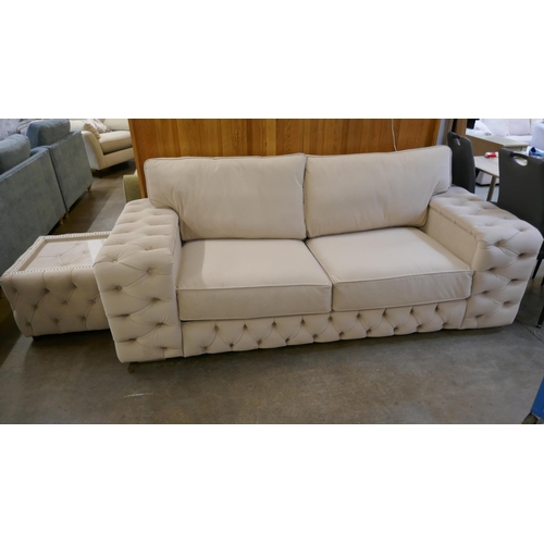 1527 - A cream three seater sofa bed and glass topped coffee table