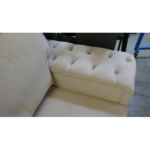 1527 - A cream three seater sofa bed and glass topped coffee table