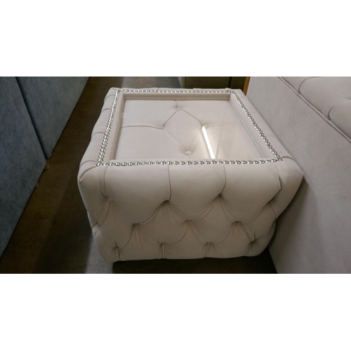 1527 - A cream three seater sofa bed and glass topped coffee table