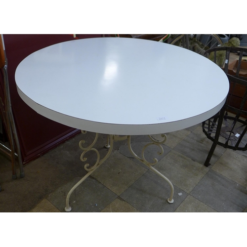 258 - A French style wrought iron based circular garden table