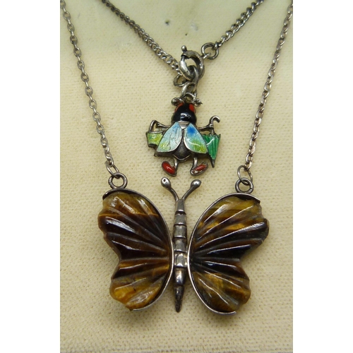 1002 - A silver set carved cats eye butterfly pendant and an enamelled insect charm on a silver bracelet