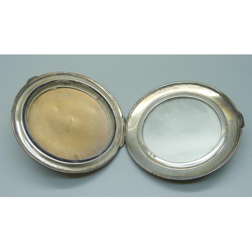 1027 - A hallmarked silver compact, 73.7g